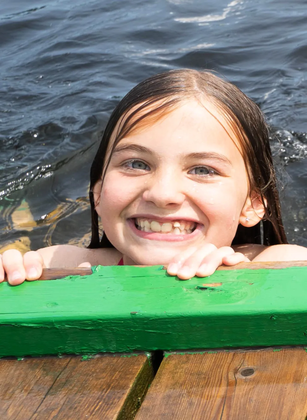 Girls swimming off the rocky shores of Beausoleil Island in Georgian Bay Islands National Park, YMCA Camp Queen Elizabeth