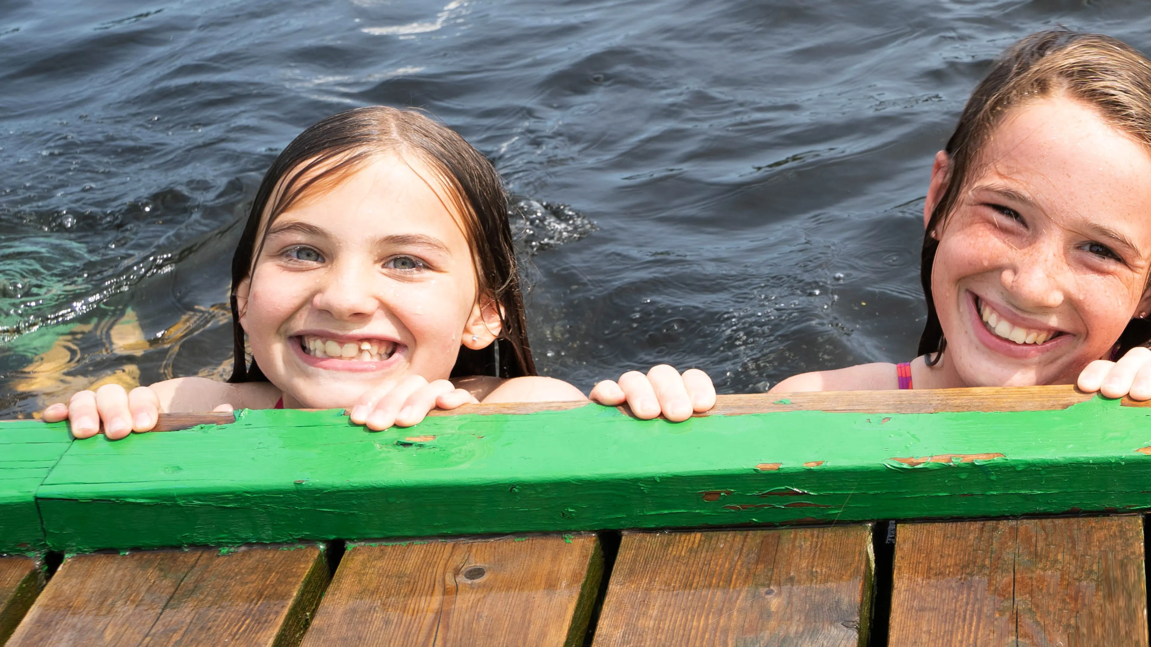 Girls swimming off the rocky shores of Beausoleil Island in Georgian Bay Islands National Park, YMCA Camp Queen Elizabeth