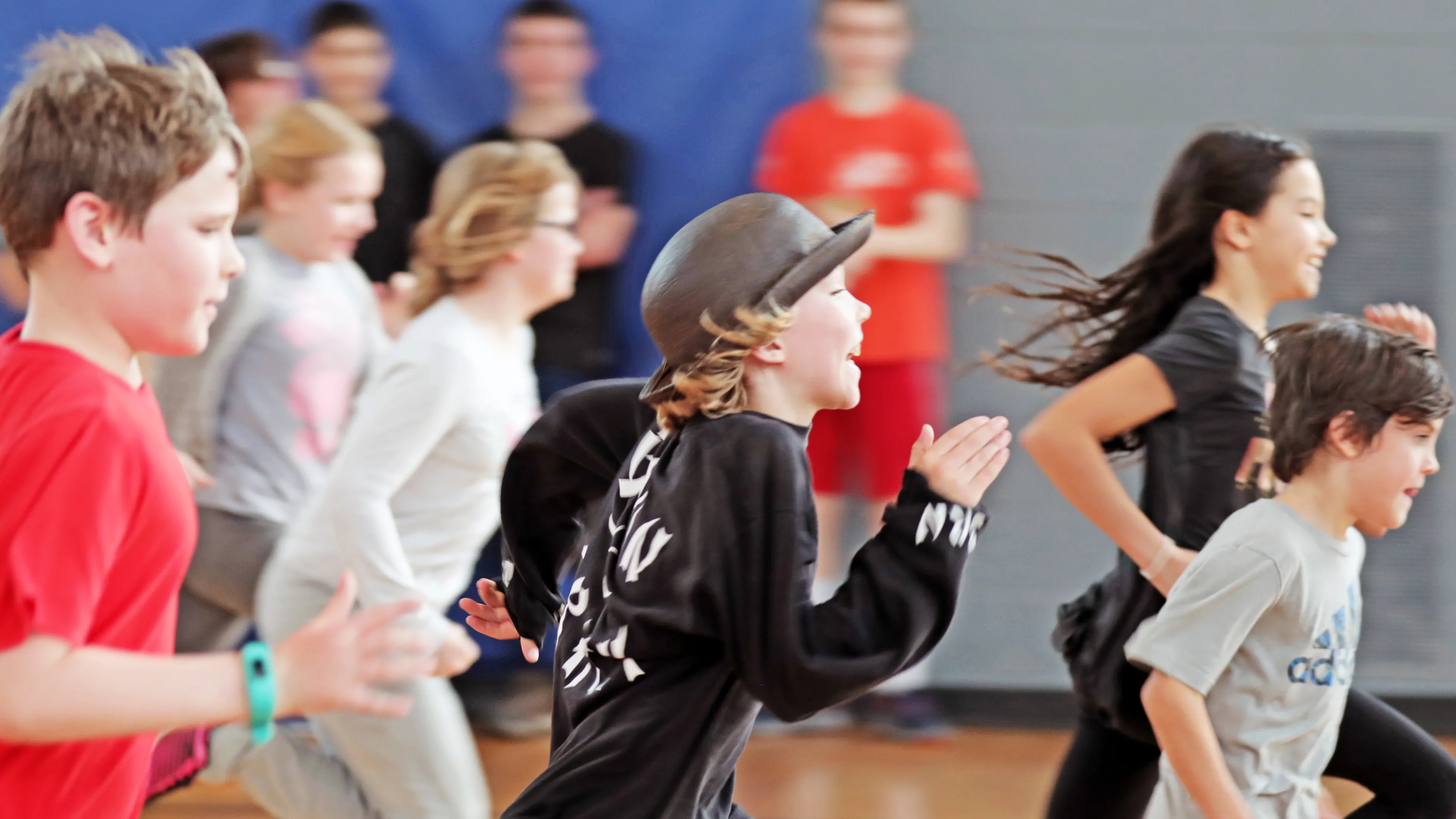 Kids running and being active at a YMCA gym