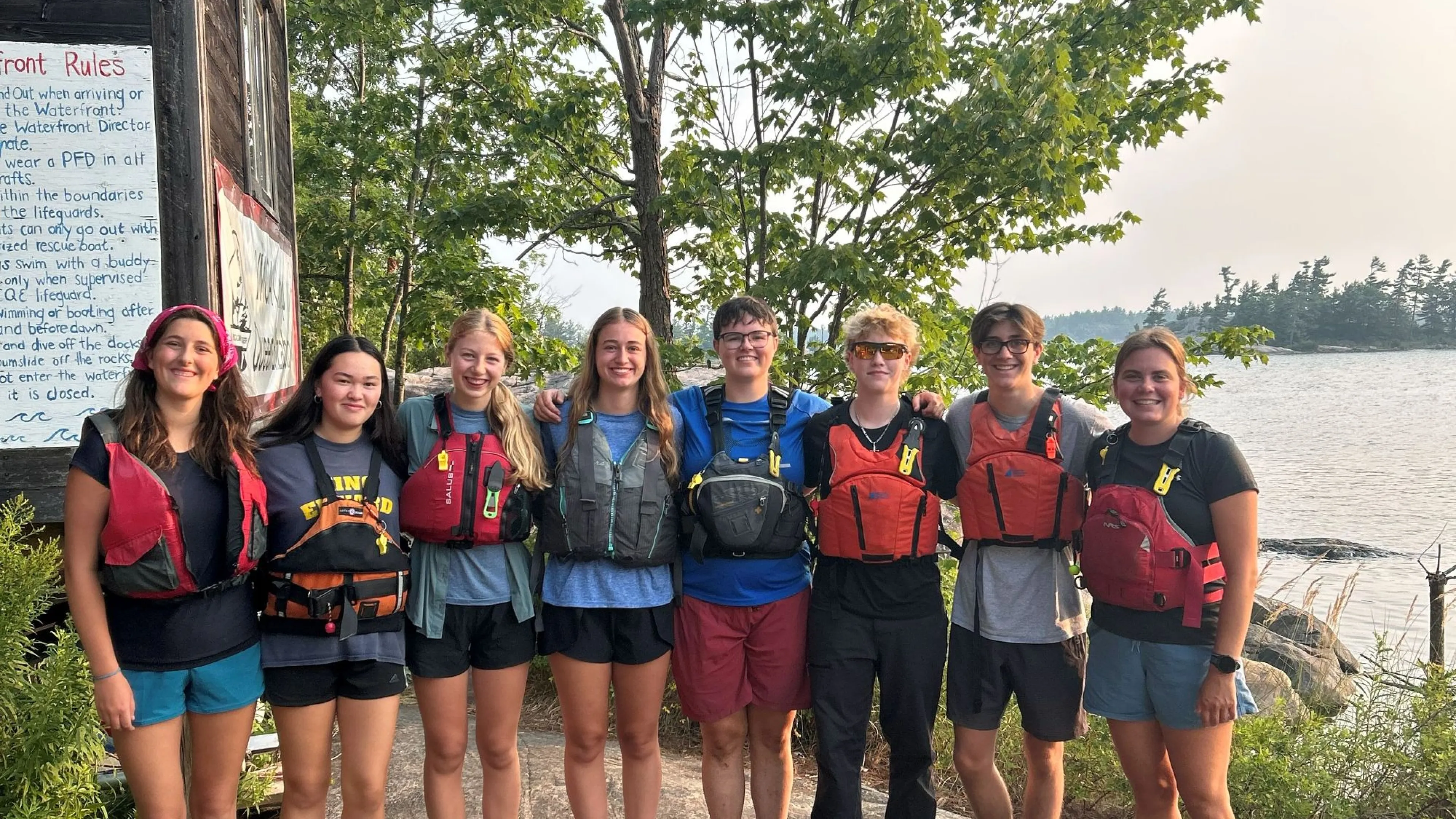 Youth standing together with life jackets on