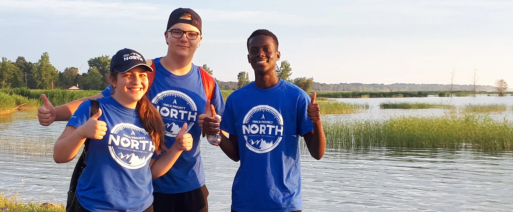 Three teens in Project North shirts