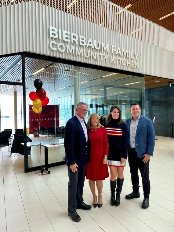 Bierbaum Family stands in front of Community Kitchen